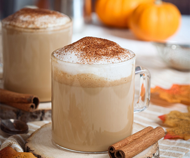 Hot cup of coffee with cinnamon sticks