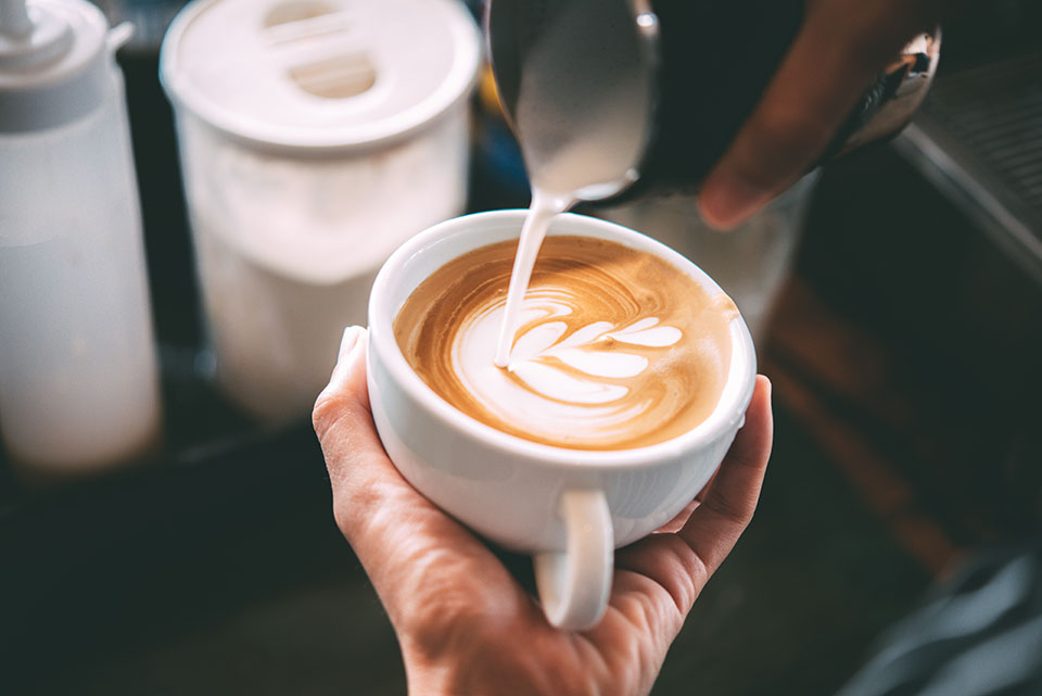 Hot cup of coffee with cream design